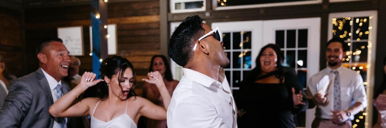 Party guests dancing under colored lights